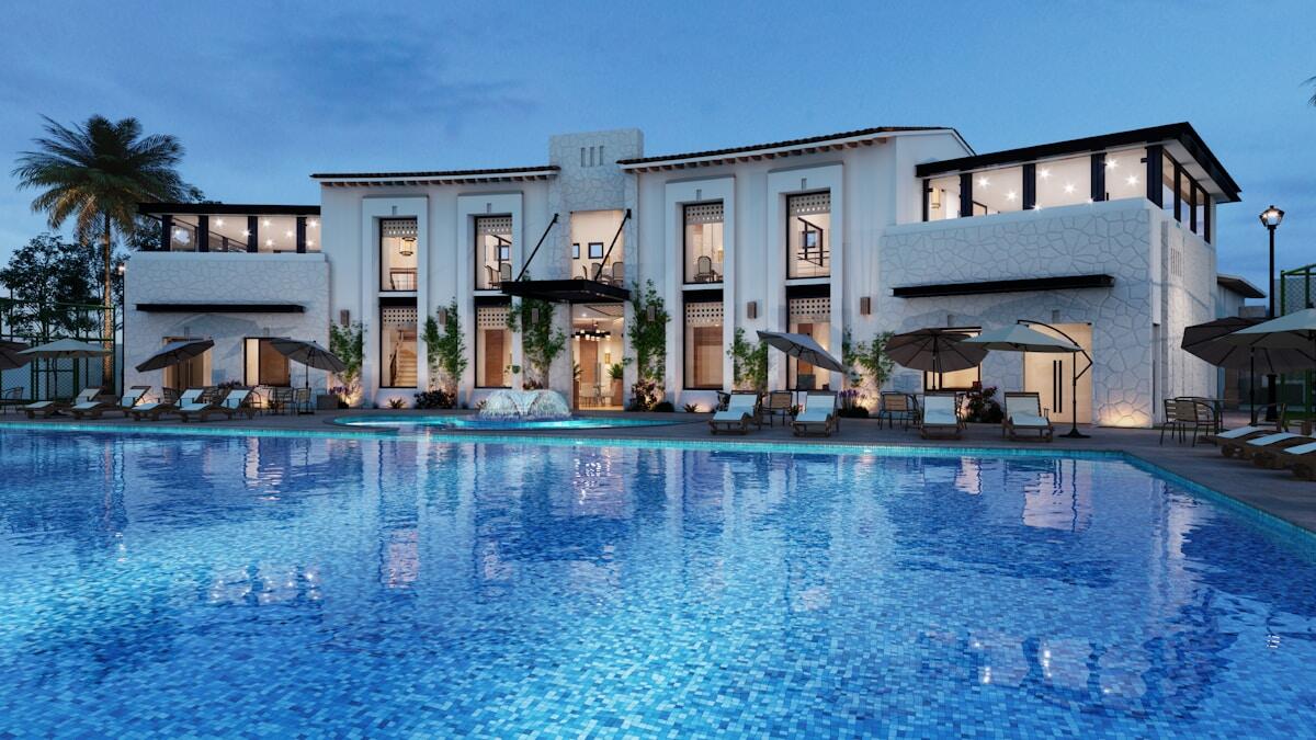 Luxury hotel exterior at sunset with illuminated entrance and modern architecture